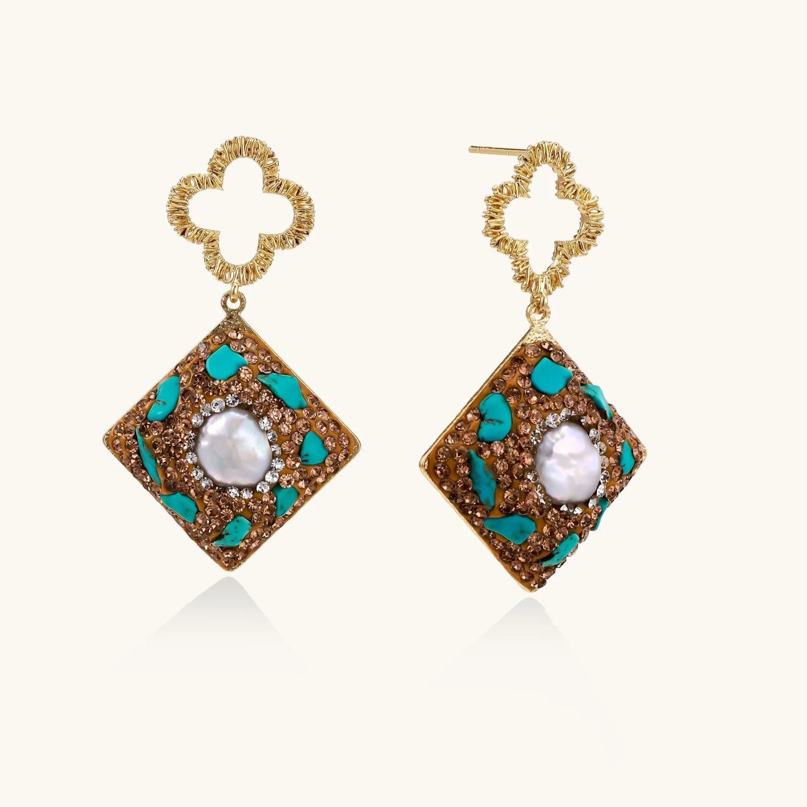 Gold-plated drop earrings with quatrefoil studs, diamond-shaped pendants featuring baroque pearls, turquoise stones, and amber crystals