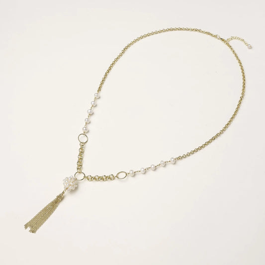 Long gold-plated necklace with freshwater pearls, chunky chain links, and flowing tassel pendant