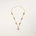 14K gold-plated necklace with eye-shaped stations and baroque pearl pendant on cream background