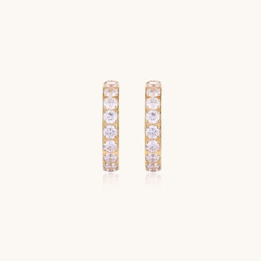 Gold pavé hoop earrings with two freshwater pearls nestled inside the curved design, featuring crystal-studded outer edge.
